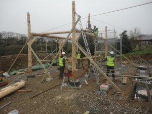 Raising the roundwood timber frame home.