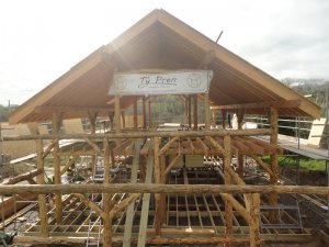 View of roundwood timberframe with workshop frame.